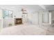 Cozy basement area with a fireplace, neutral colors, and modern ceiling fan at 6183 Xavier St, Arvada, CO 80003