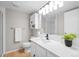 Updated bathroom with modern fixtures, vanity, large mirror, and stylish lighting at 6183 Xavier St, Arvada, CO 80003