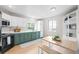 Bright kitchen with modern black appliances, stylish green cabinets, and ample counter space at 6183 Xavier St, Arvada, CO 80003