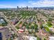 An aerial view shows a home nestled in a neighborhood with Denver's skyline in the background at 1024 34Th St, Denver, CO 80205