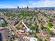 An aerial view shows a home nestled in a neighborhood with Denver's skyline in the background at 1024 34Th St, Denver, CO 80205