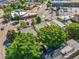 An aerial view shows a home with mature trees, nearby businesses and a view of the surrounding neighborhood at 1024 34Th St, Denver, CO 80205