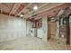 Unfinished basement with laundry area and herringbone tile flooring at 1024 34Th St, Denver, CO 80205