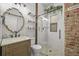 Stylish bathroom with a glass shower, mosaic tile floor, and updated vanity at 1024 34Th St, Denver, CO 80205