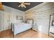 Stylish bedroom featuring wood paneling, a modern ceiling fan, and contemporary decor accents at 1024 34Th St, Denver, CO 80205