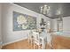 Elegant dining room featuring a decorative painting, chandelier, and cozy fireplace with rustic accents at 1024 34Th St, Denver, CO 80205