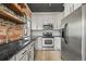 Modern kitchen featuring stainless steel appliances, granite countertops, and white cabinets at 1024 34Th St, Denver, CO 80205