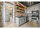 Charming kitchen features exposed brick, open shelving, modern appliances, and updated countertops at 1024 34Th St, Denver, CO 80205