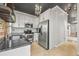 Modern kitchen boasts stainless steel appliances, granite countertops, and ample cabinet space for storage at 1024 34Th St, Denver, CO 80205