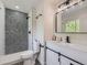 Modern bathroom with stylish black-and-white tile shower, contemporary fixtures, and a vanity with storage at 3793 S Sebring Ct, Denver, CO 80237
