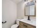 Powder room featuring a modern vanity with a wood cabinet and contemporary fixtures at 3793 S Sebring Ct, Denver, CO 80237