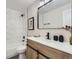 Bathroom featuring modern black hardware, a bathtub with marble tile, and contemporary fixtures at 3793 S Sebring Ct, Denver, CO 80237