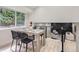 Modern dining room with a stylish table and chairs, complemented by natural light and an open floor plan at 3793 S Sebring Ct, Denver, CO 80237