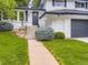 Close-up of the home's entrance featuring a well-manicured lawn and updated stairs at 3793 S Sebring Ct, Denver, CO 80237