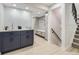 Hallway area with custom cabinets, drawers, and a staircase leading to the upper level at 3793 S Sebring Ct, Denver, CO 80237