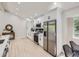 Updated kitchen with stainless steel appliances, subway tile backsplash, and lots of natural light at 3793 S Sebring Ct, Denver, CO 80237