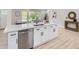 Bright kitchen featuring white cabinets, stainless steel appliances, and a large island with a sink at 3793 S Sebring Ct, Denver, CO 80237