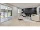 Cozy living room with a modern fireplace, neutral-toned furniture, and sliding glass doors to the backyard at 3793 S Sebring Ct, Denver, CO 80237
