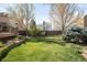 Lush backyard featuring a well-manicured lawn and beautiful landscaping with mature trees and stone accents at 1437 Cassin Ct, Boulder, CO 80303