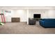 Spacious finished basement with neutral carpet, a blue couch, and entertainment area at 1437 Cassin Ct, Boulder, CO 80303