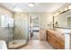 Bright bathroom featuring a glass shower, soaking tub, dual vanity and access to the main bedroom at 1437 Cassin Ct, Boulder, CO 80303
