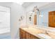 Bright bathroom featuring a granite countertop, wooden cabinets and double sinks at 1437 Cassin Ct, Boulder, CO 80303