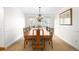 Formal dining room featuring a large wooden table, chandelier, and bright windows at 1437 Cassin Ct, Boulder, CO 80303