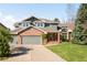 Charming two-story home features a well-manicured lawn, brick accents, and an attached two-car garage at 1437 Cassin Ct, Boulder, CO 80303