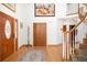 Bright foyer with hardwood floors, a striking staircase, and closet for coats and shoes at 1437 Cassin Ct, Boulder, CO 80303