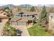 Inviting two-story home with a well-maintained lawn, mature trees, and a three-car garage at 1437 Cassin Ct, Boulder, CO 80303
