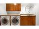 Functional laundry room with washer, dryer, sink, countertop, and storage cabinets at 1437 Cassin Ct, Boulder, CO 80303