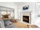 Cozy living room with a fireplace, large mantel, and open access to the dining area at 1437 Cassin Ct, Boulder, CO 80303