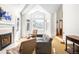 Bright living room with fireplace, large windows with shutters, and comfortable seating at 1437 Cassin Ct, Boulder, CO 80303