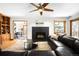 Living room with fireplace, ceiling fan, hardwood floors and lots of natural light at 1437 Cassin Ct, Boulder, CO 80303