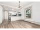 Bright living room features hardwood floors, and an open floor plan to the kitchen at 2705 - 2707 N Lafayette St, Denver, CO 80205