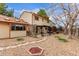 Spacious backyard featuring a covered patio, lush landscaping, and stone pathway at 18434 E Belleview Ln, Centennial, CO 80015