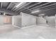 Spacious basement with sleek tile floors, open ceiling, and potential for customization and expansion at 18434 E Belleview Ln, Centennial, CO 80015