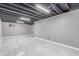 Spacious basement featuring new tile floors, exposed ceiling rafters and freshly painted walls at 18434 E Belleview Ln, Centennial, CO 80015