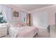 Charming bedroom with a soft pink color scheme, cozy textiles, and natural light from the large window at 18434 E Belleview Ln, Centennial, CO 80015
