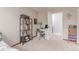 Comfortable bedroom with a desk area, a bookshelf, and neutral walls, creating a versatile space at 18434 E Belleview Ln, Centennial, CO 80015