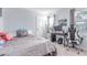 Bright bedroom featuring carpeted floors, two windows and a comfy-looking bed, offering style and relaxation at 18434 E Belleview Ln, Centennial, CO 80015