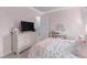 Comfortable bedroom featuring a dresser, a vanity with a mirror and a bed with patterned linens and pillows at 18434 E Belleview Ln, Centennial, CO 80015