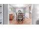 Elegant dining room with hardwood floors, a classic table, and access to the kitchen at 18434 E Belleview Ln, Centennial, CO 80015