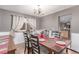 Dining area featuring a wooden table set for six, chandelier lighting, and natural light from windows at 18434 E Belleview Ln, Centennial, CO 80015