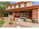 Charming two-story home featuring a brick facade, covered porch, and well-manicured landscaping at 18434 E Belleview Ln, Centennial, CO 80015