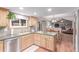 Open concept kitchen with stainless steel appliances, tile countertops and backsplash, and hardwood floors at 18434 E Belleview Ln, Centennial, CO 80015