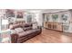Cozy living room boasting hardwood floors, a comfortable sofa, and natural light from the windows at 18434 E Belleview Ln, Centennial, CO 80015