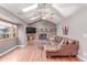 Cozy living room features vaulted ceilings, brick fireplace, hardwood floors and oversized sectional sofa at 18434 E Belleview Ln, Centennial, CO 80015