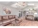 Relaxing living room features a vaulted ceiling, hardwood floors, and view to the kitchen at 18434 E Belleview Ln, Centennial, CO 80015