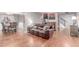 Comfortable living area with hardwood floors, a plush sofa, and easy access to the dining room at 18434 E Belleview Ln, Centennial, CO 80015